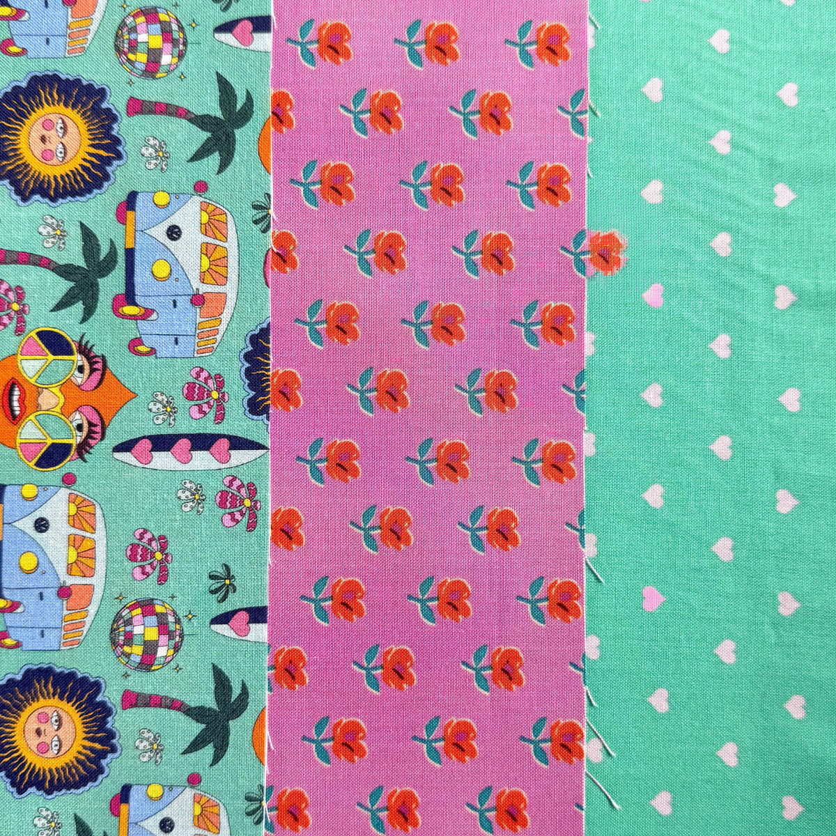 Three coordinating fabric prints side by side: retro campervans and sunshine faces on mint, orange flowers on pink and tiny hearts on mint.