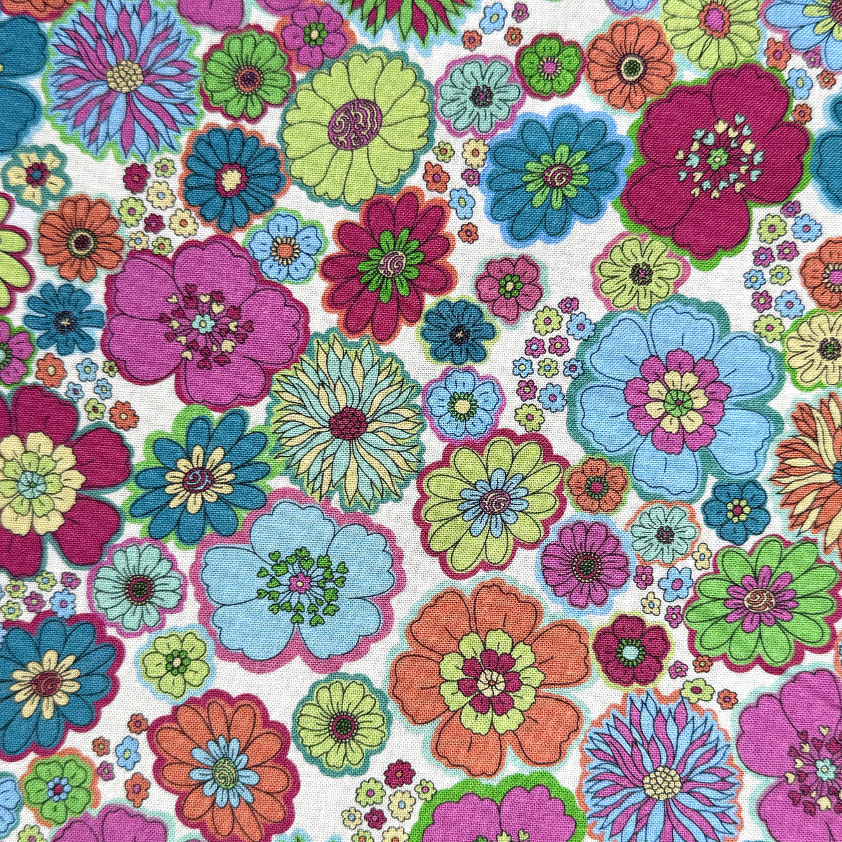 60s-inspired floral fabric laid flat, featuring pink, orange, blue, teal and lime green retro flowers on a light off white background.