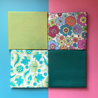 Four folded fat quarters arranged in a square, with two floral prints and coordinating plain lime and teal fabrics.