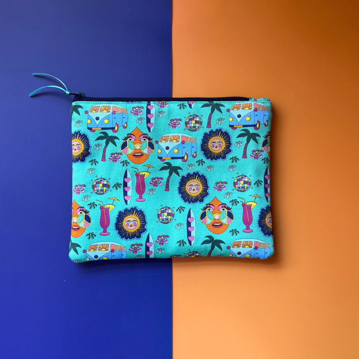 Back of the medium turquoise Hippie Pouch, showing colourful campervans, surfboards, cocktails and peace-sign sunglasses.