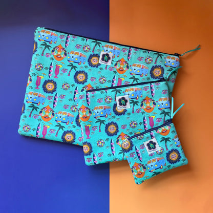 Three turquoise Hippie Pouches in small, medium and large sizes with a navy zip and teal ribbon. The fabric a colourful retro design featuring camper vans, palm trees, suns, disco balls, surfboard and cocktail glasses.