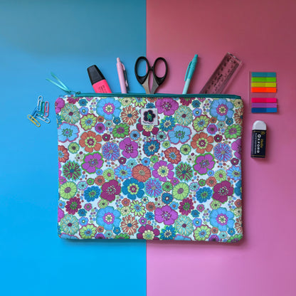 Large 60s floral zip pouch featuring colourful fabric with retro inspired florals. Shown with pens, scissors, a ruler and other stationery.