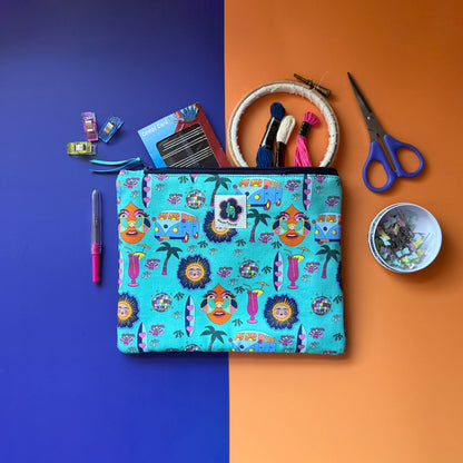 Medium turquoise Hippie Pouch with retro print, shown with an embroidery hoop, threads, scissors and sewing supplies.