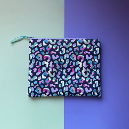 Back of the medium zip pouch, showing pink, blue, mint and lilac leopard spots on a dark navy background.