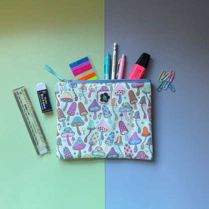 Medium mushroom-print zip pouch shown with pens, a pencil, highlighter, ruler and paper clips.