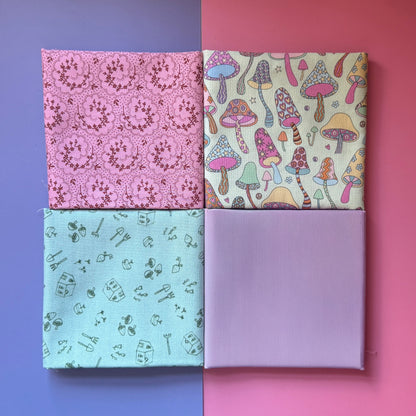  Four folded fat quarters arranged in a square, showing pink florals, colourful mushrooms, sage green gardening motifs and plain lilac.