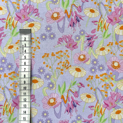 Retro Bloom floral fabric beside a centimetre tape measure to show the scale of the flower pattern.