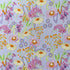 Retro Bloom fabric laid flat, featuring pink blooms, pale yellow daisies, tiny purple flowers and orange details on a pale lilac background.