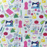 Sewing-themed fabric laid flat, featuring colourful sewing machines, scissors, dress forms, pin cushions, tape measures and irons on a light blue background.