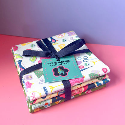 Sewing fat quarter bundle tied with a navy ribbon and finished with a turquoise ByLouMoffat label.