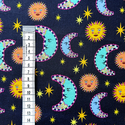 Sun and moon fabric beside a centimetre tape measure to show the scale of the celestial pattern.